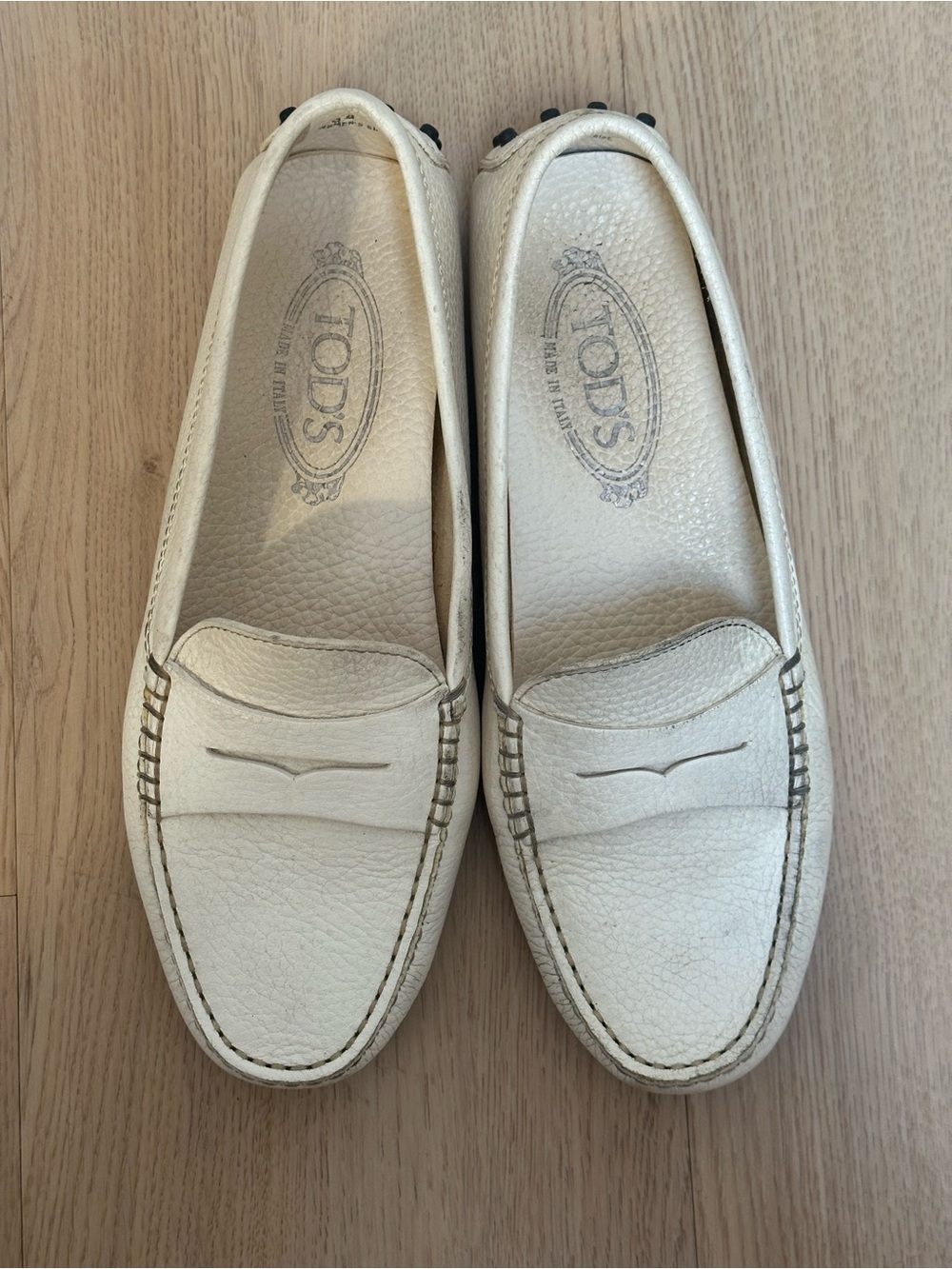 Tod's Ivory Pebbled Leather Penny Loafers